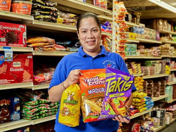Employee carrying tostadas, plantain chips and Takis.